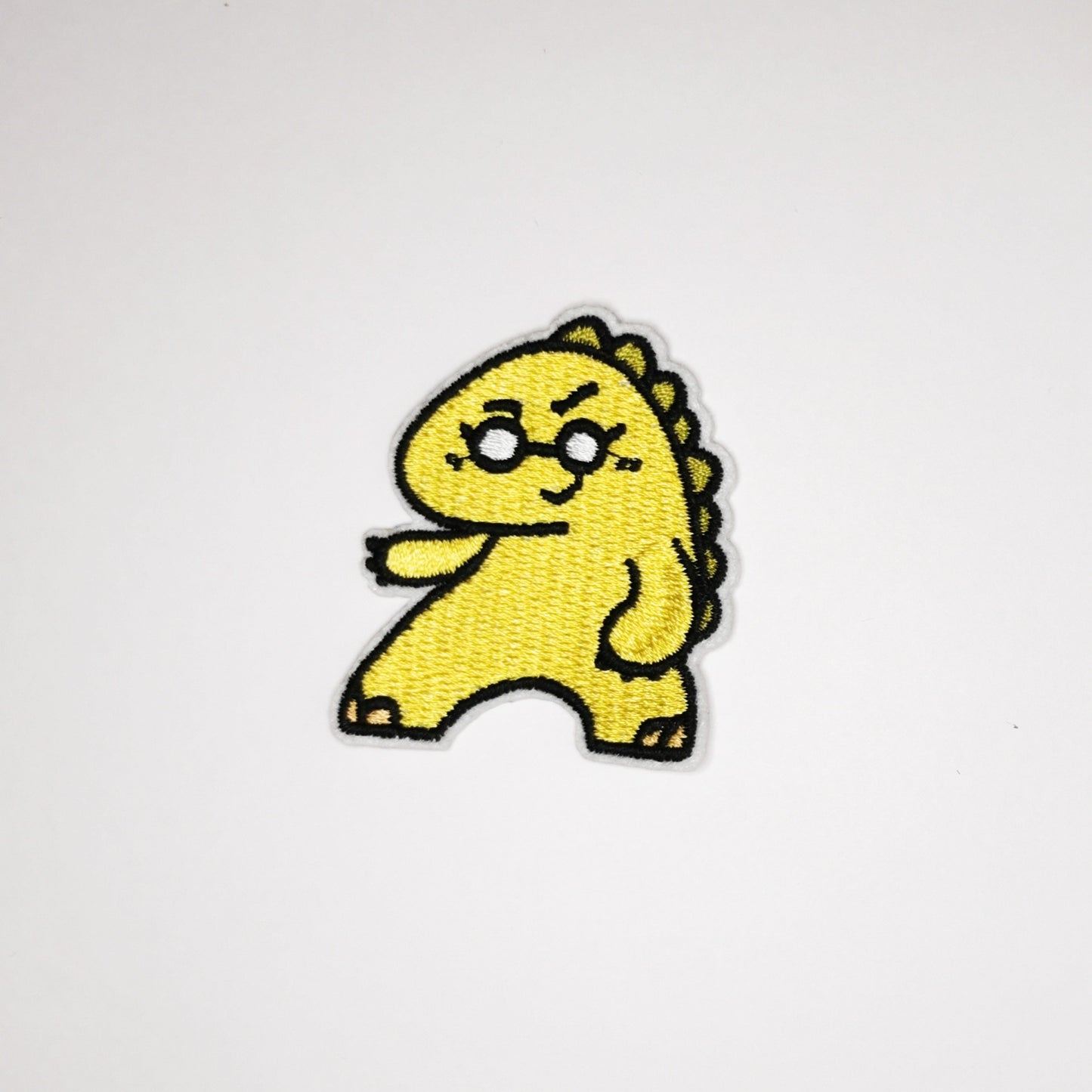 Strykelapp med motiv av Dansende Dino