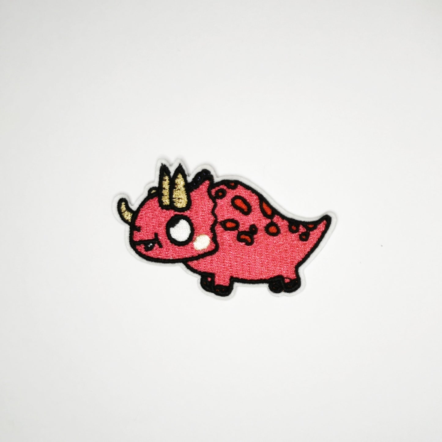 Strykelapp med motiv av Kikkende Dino