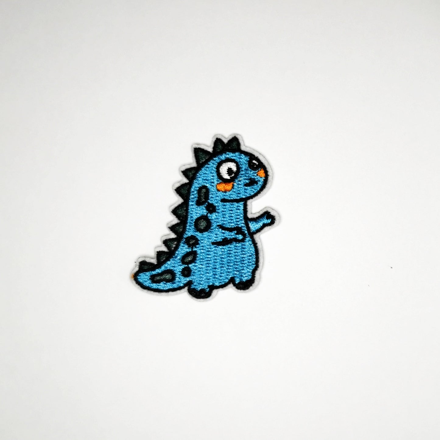 Strykelapp med motiv av Blå Dino