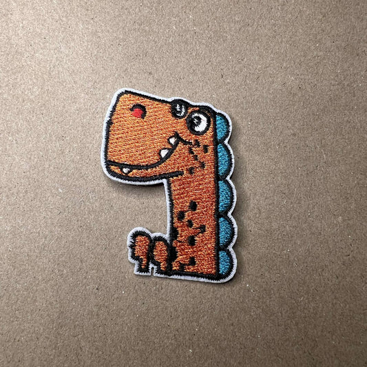 Strykelapp med motiv av Orange og blå Dino
