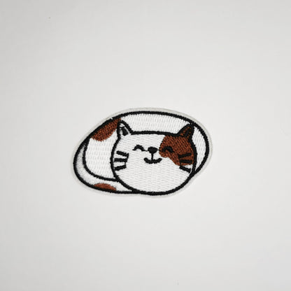 Brodert strykemerke med katt som smiler