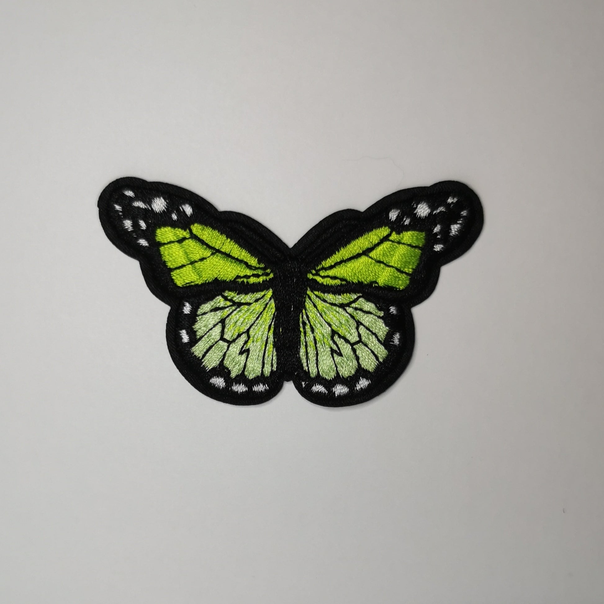Brodert strykemerke, limegrønn sommerfugl